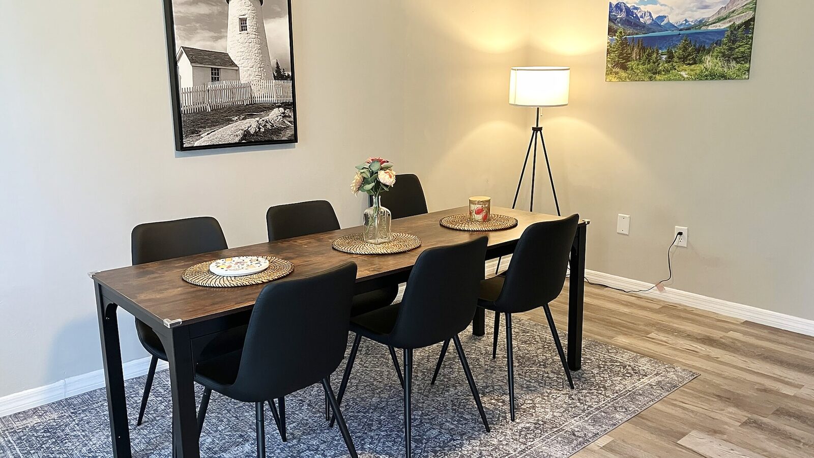 Sarasota house dining area with a wooden table, black chairs and a floor lamp