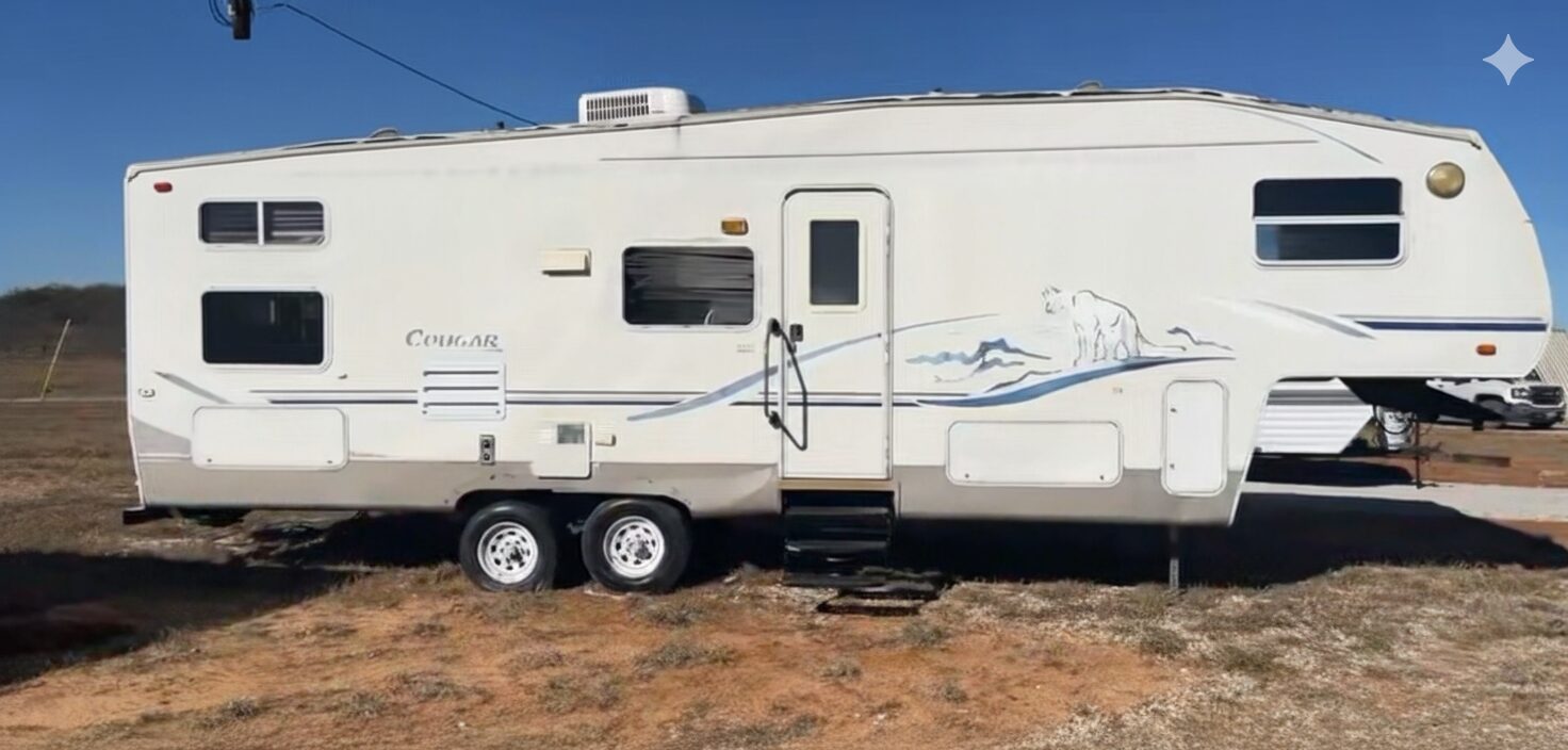 White travel trailer parked on an open RV lot in Comanche, Texas