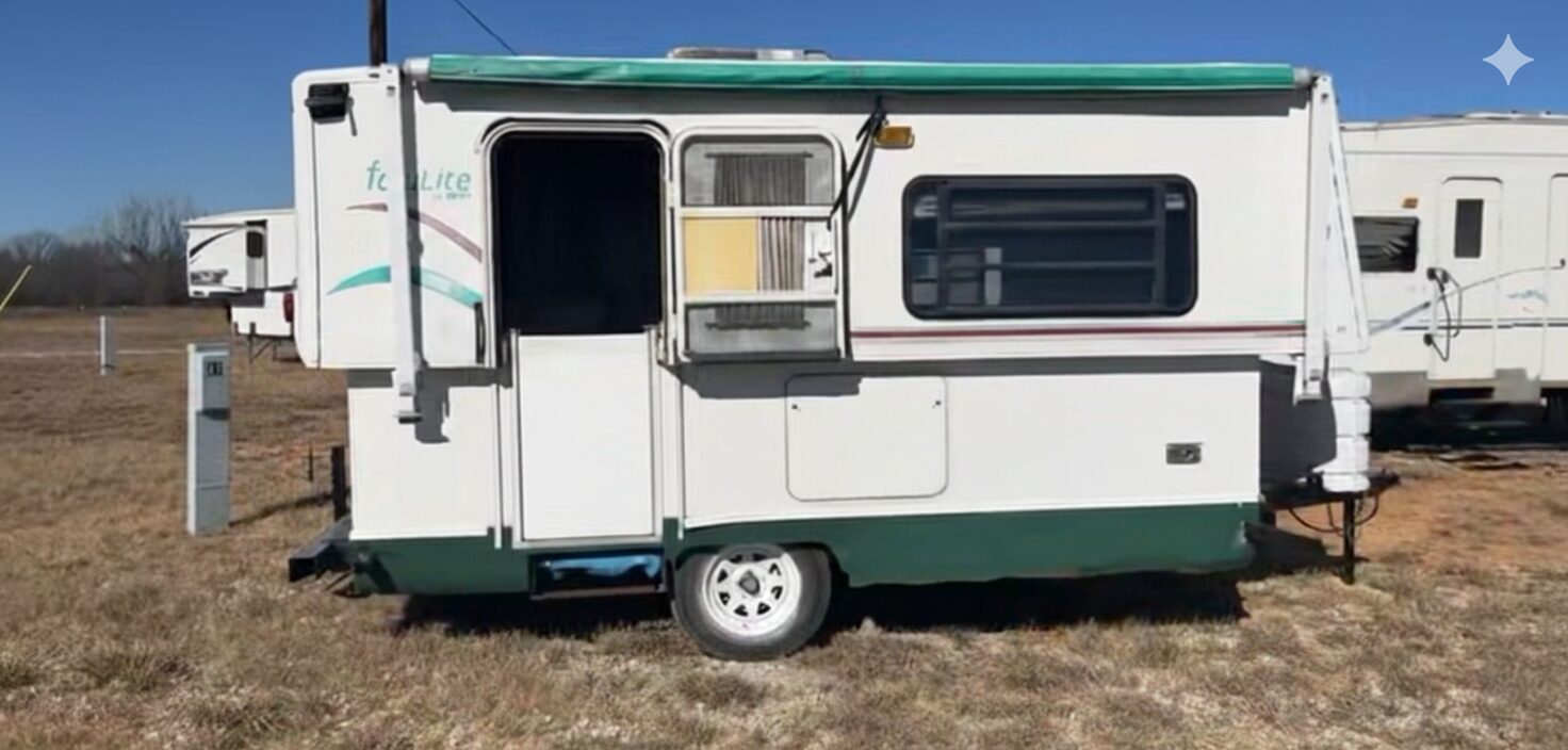 Travel trailer with a green awning on an RV lot in Comanche, Texas